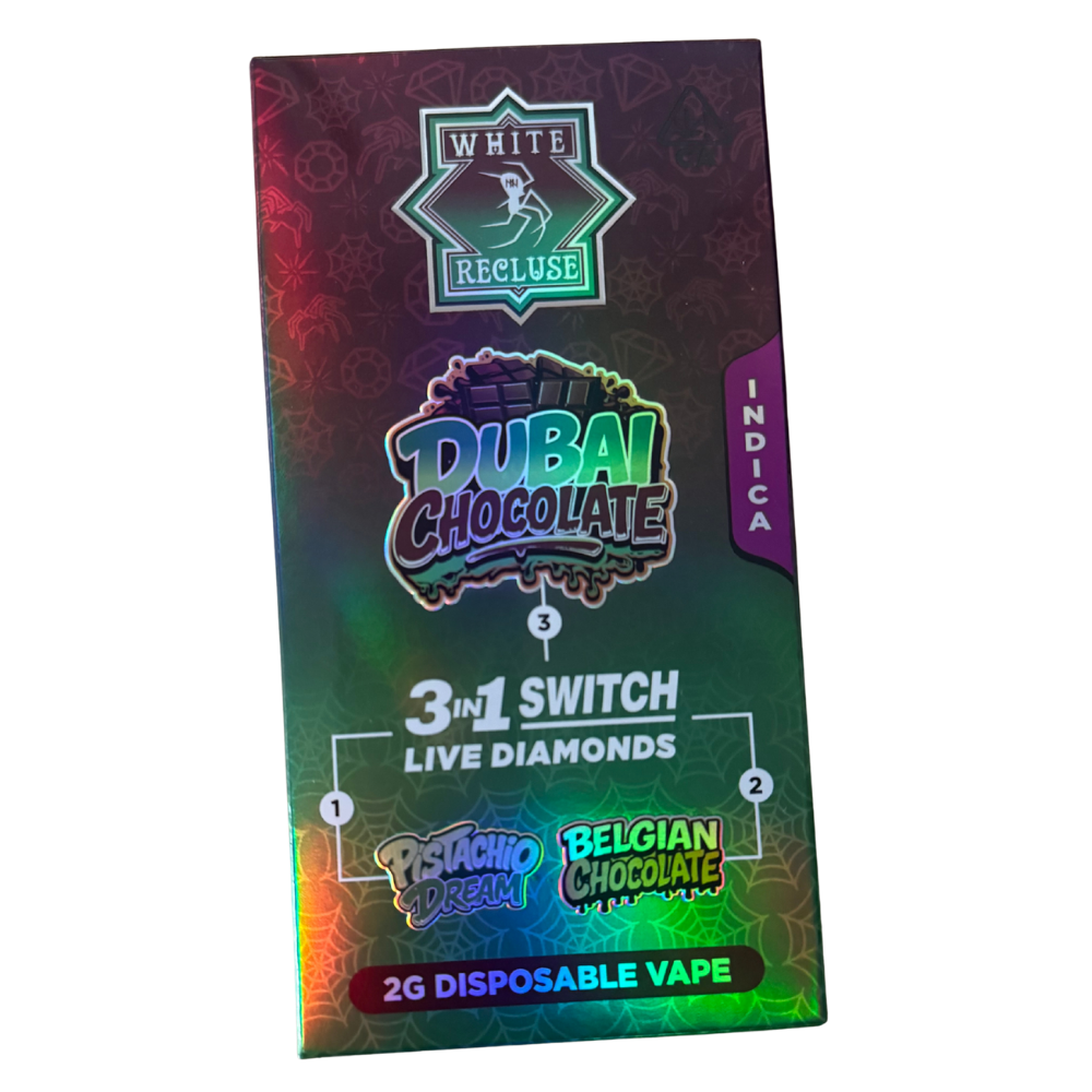 White Recluse Switch 2g – Dubai Chocolate Disposable Pen – Live Diamonds (Indica) Packaging for a Dubai Chocolate 3‑in‑1 Switch Live Diamonds 2G disposable vape; flavors Pistachio Dream and Belgian Chocolate.